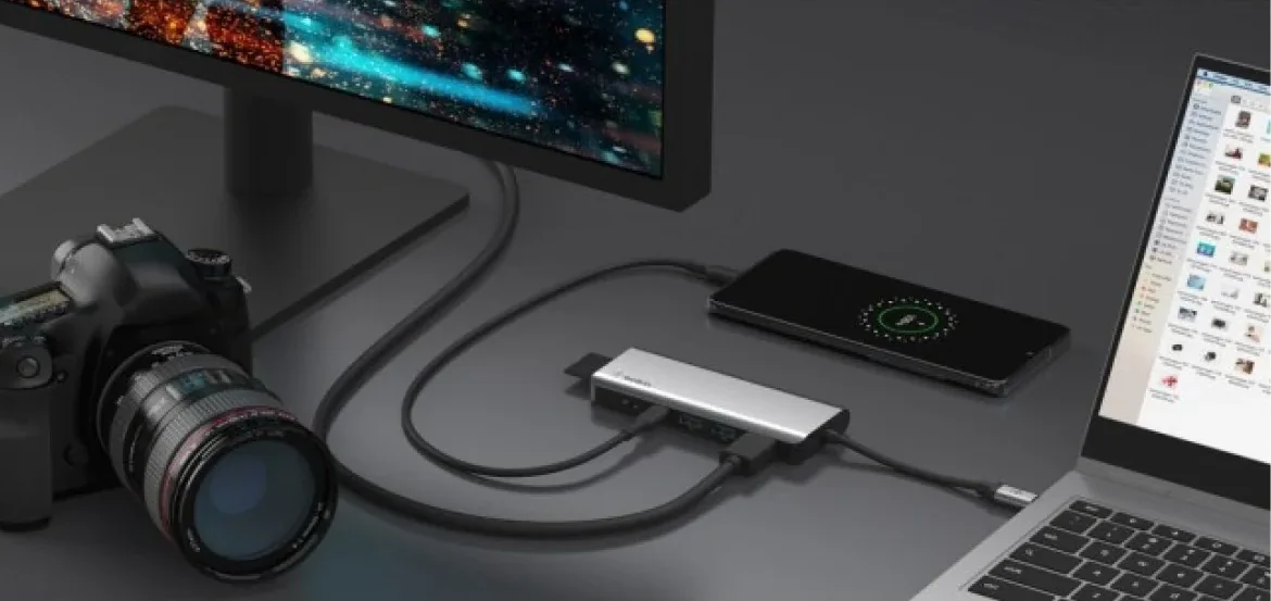 Belkin Connect AVC009 hub connecting peripherals beside a laptop on a dark desk